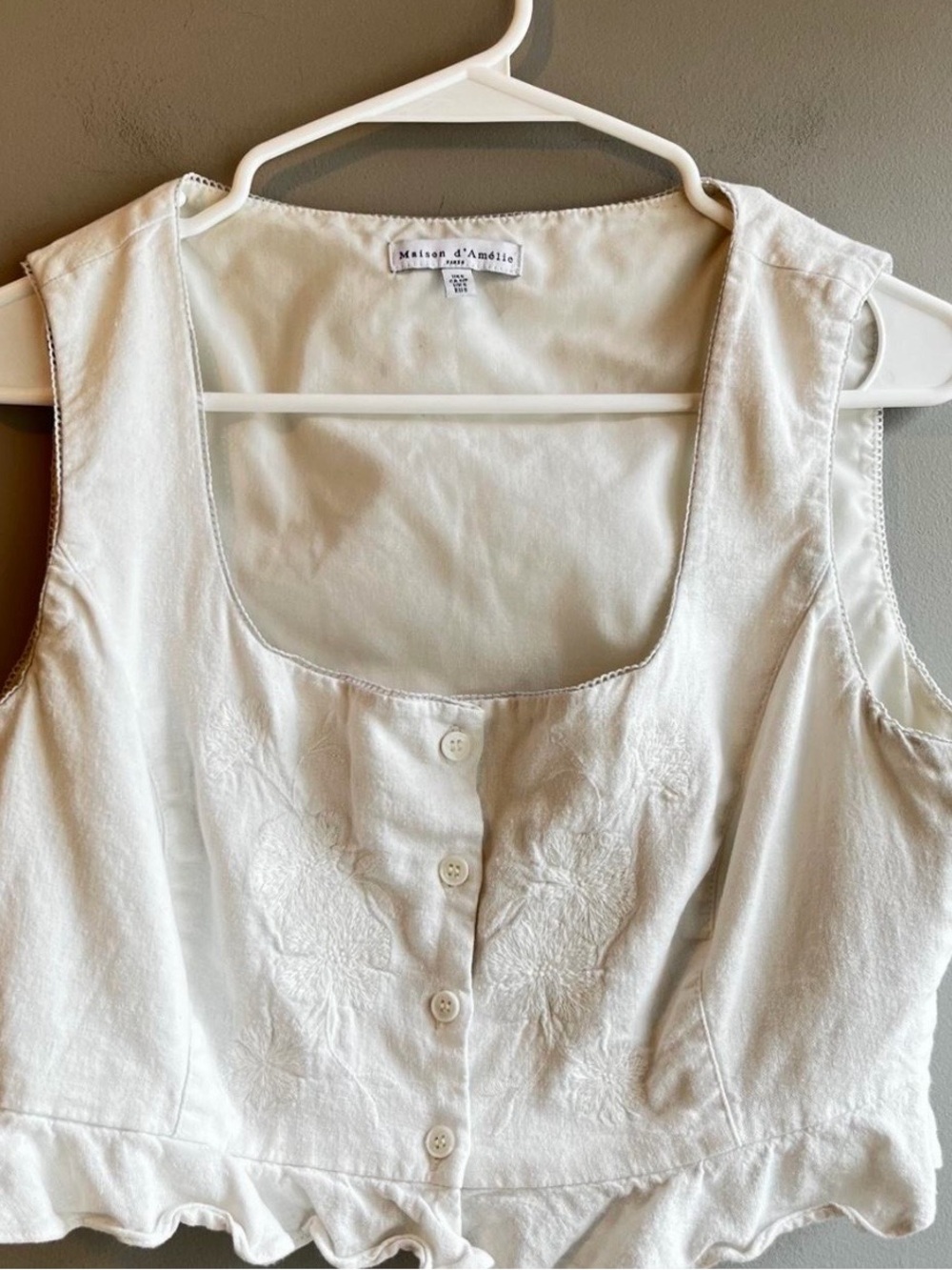 Maison d'Amelie cream linen corset top with button front and floral embroidery.